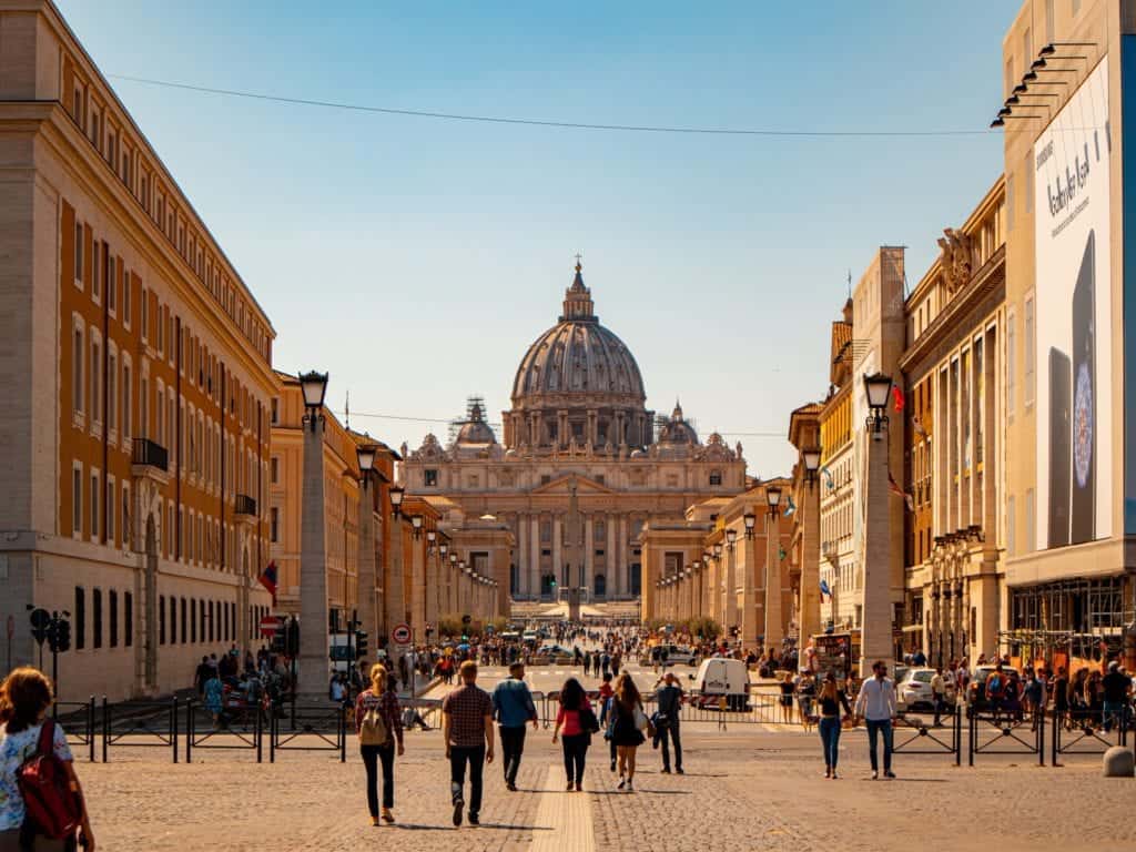 Basilica di San Pietro also known as Peterskyrkan shown from above during daytime with people walking.