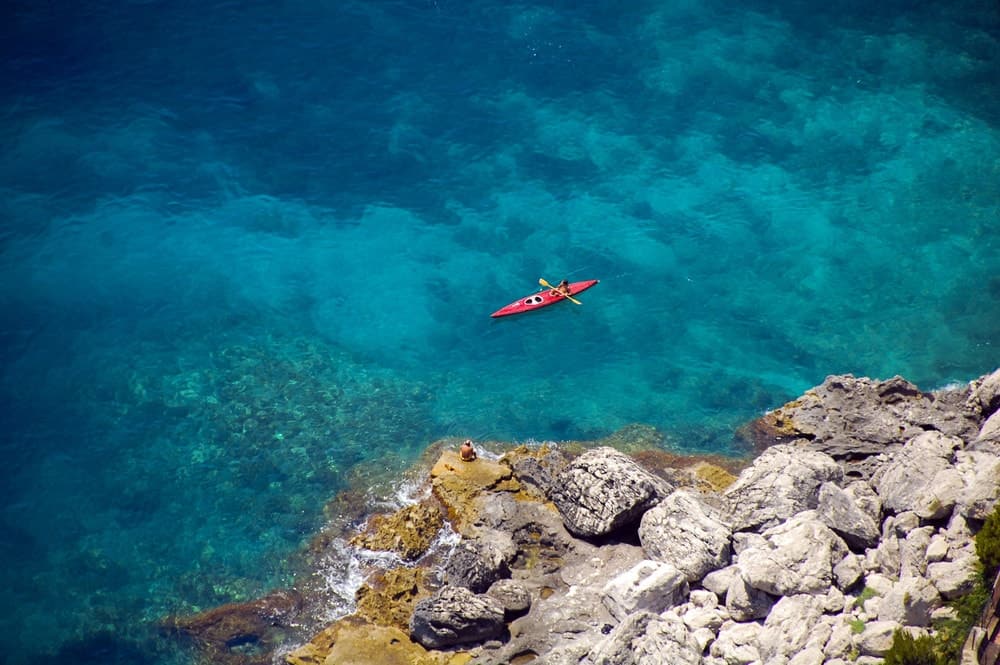 Lonely rafter with his kayak in Cinque terre, italy.