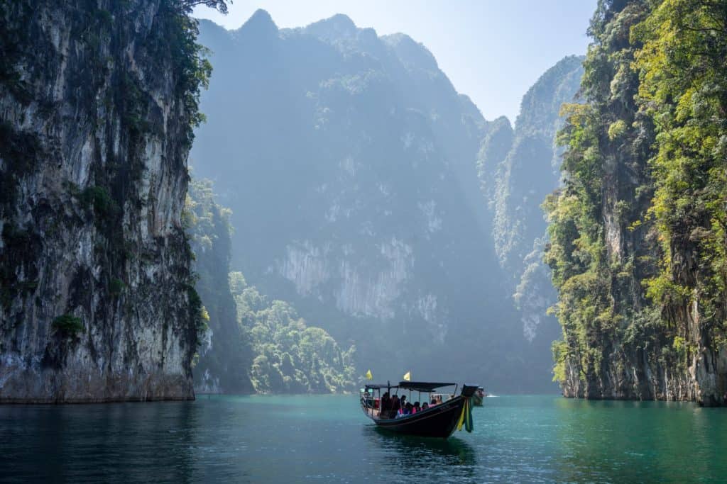 Motorbåt mellan klippor thailand.